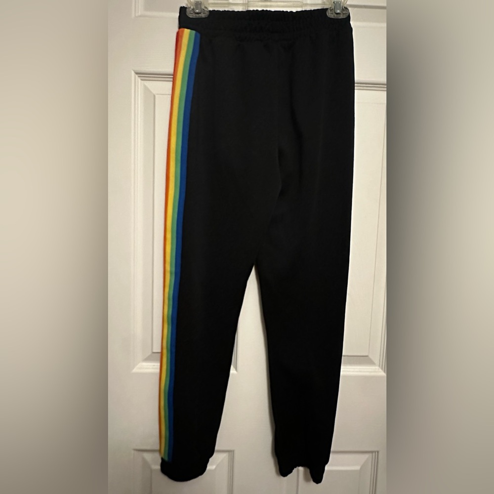 Black joggers with rainbow stripes down both legs